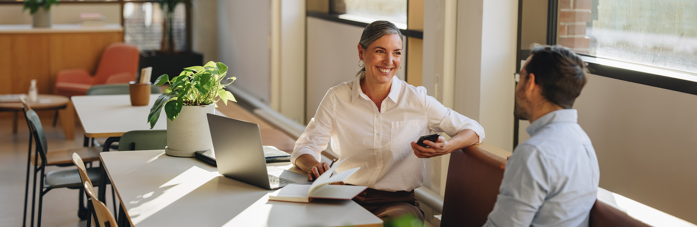 smiling professional looking woman with some grey hair