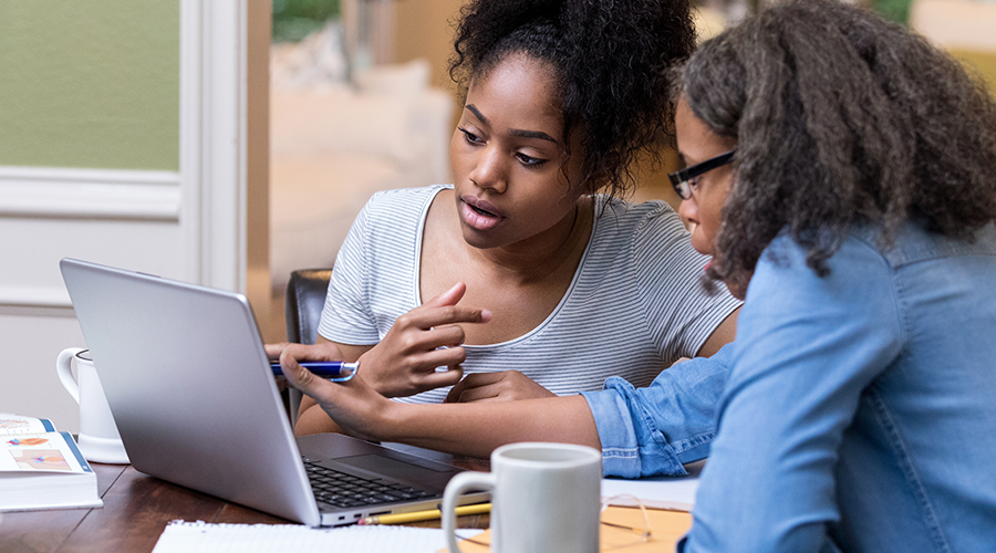 Young students and her parent working on the laptop