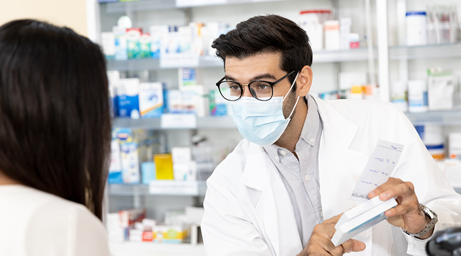 Male pharmacist advising a client