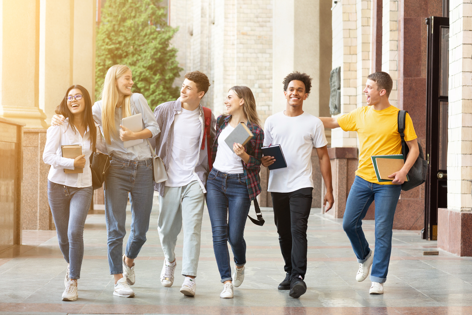 Diverse students walking together in campus, having break after classes