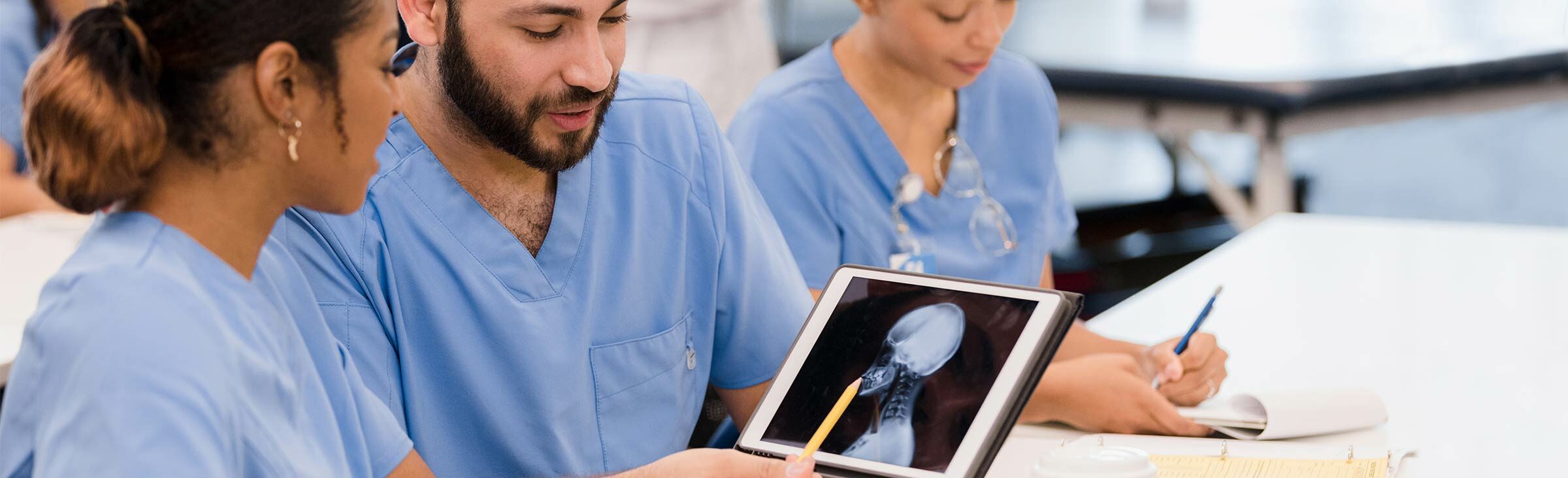 Photo of health care professionals examining an x-ray