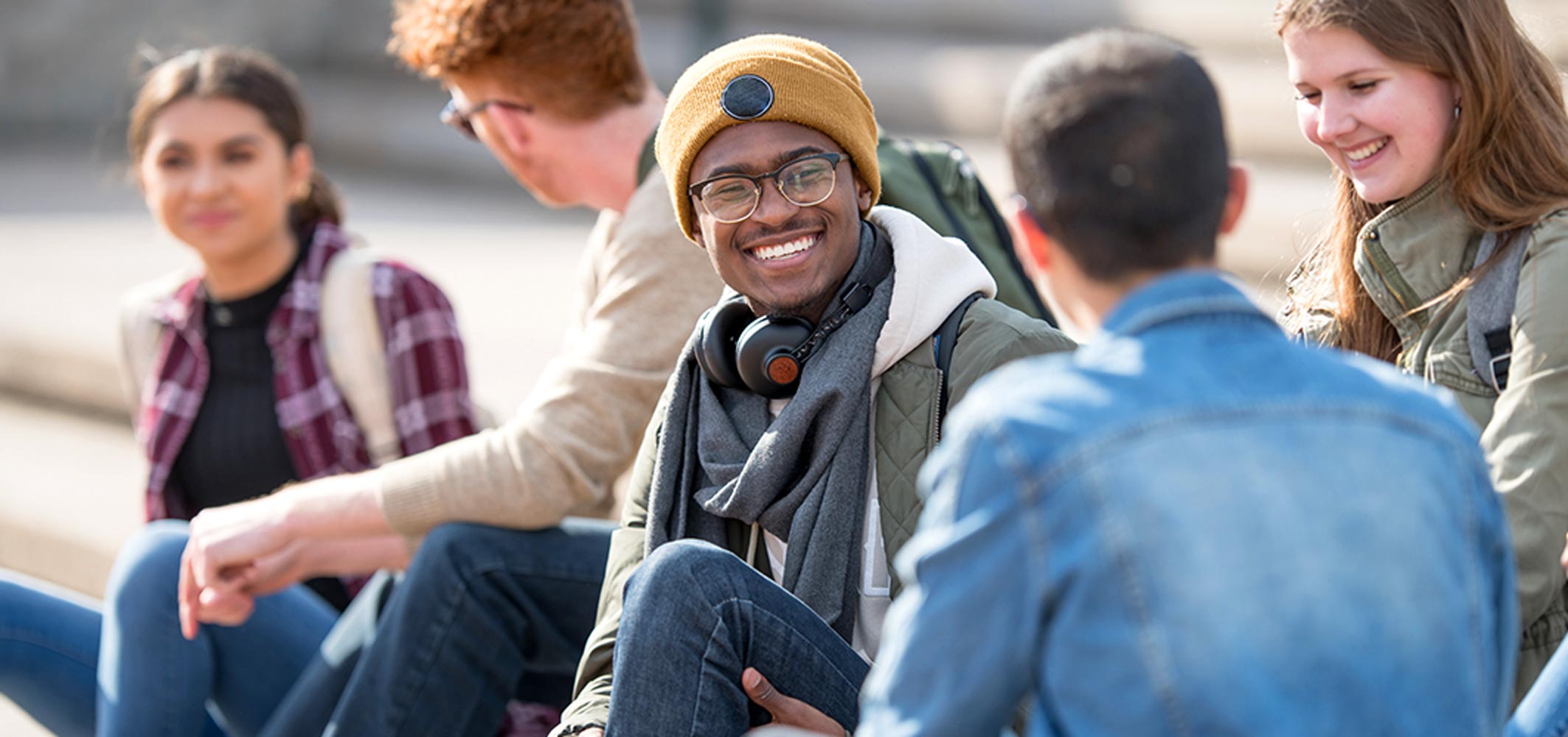 Smiling students having a conversation at one of the best colleges in Alberta for international students.